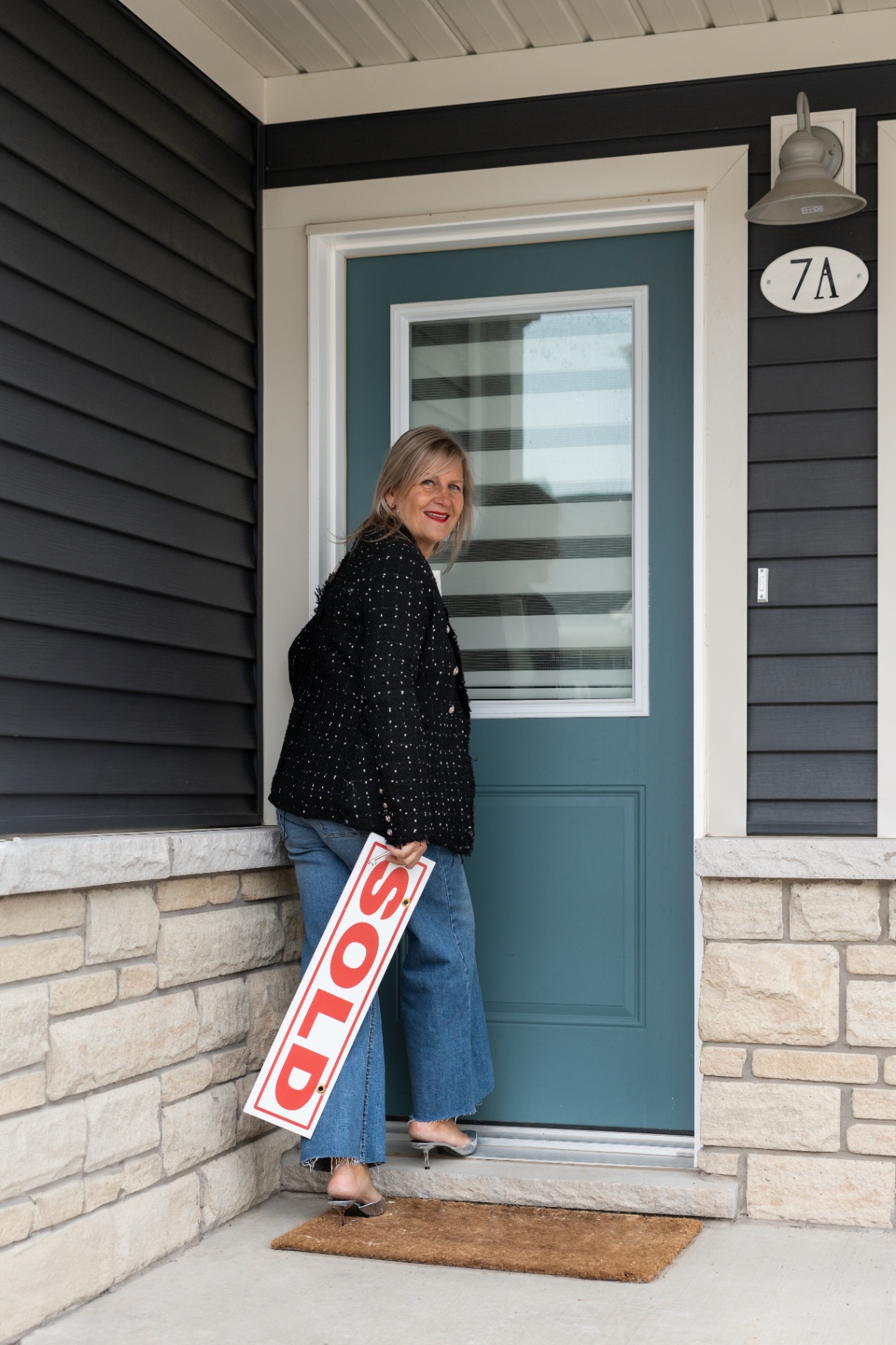 Karen at the front door of a sold home